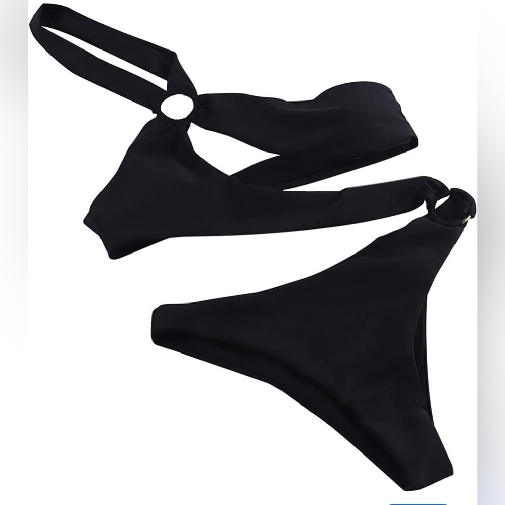black Brazilian bikini swimsuit L laid out  textured surface, likely a towel.